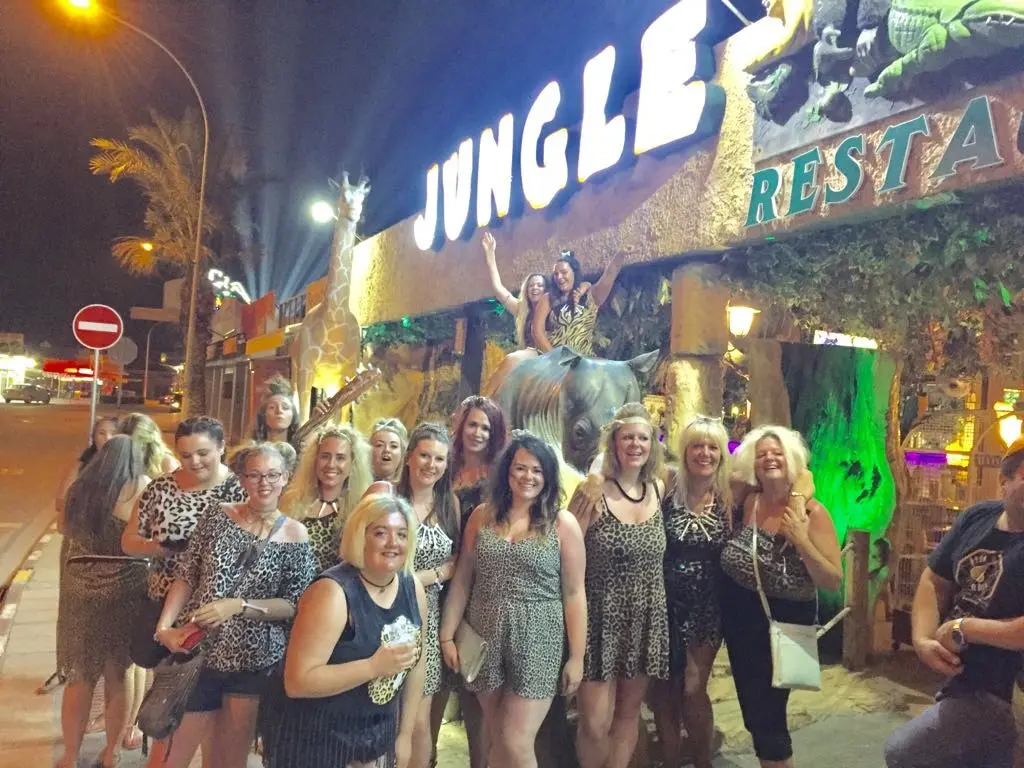 A group outside Jungle Mania in Ayia Napa at night, under the lit restaurant sign